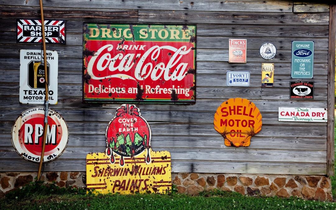 Metal signs of Coca Cola and other brand names