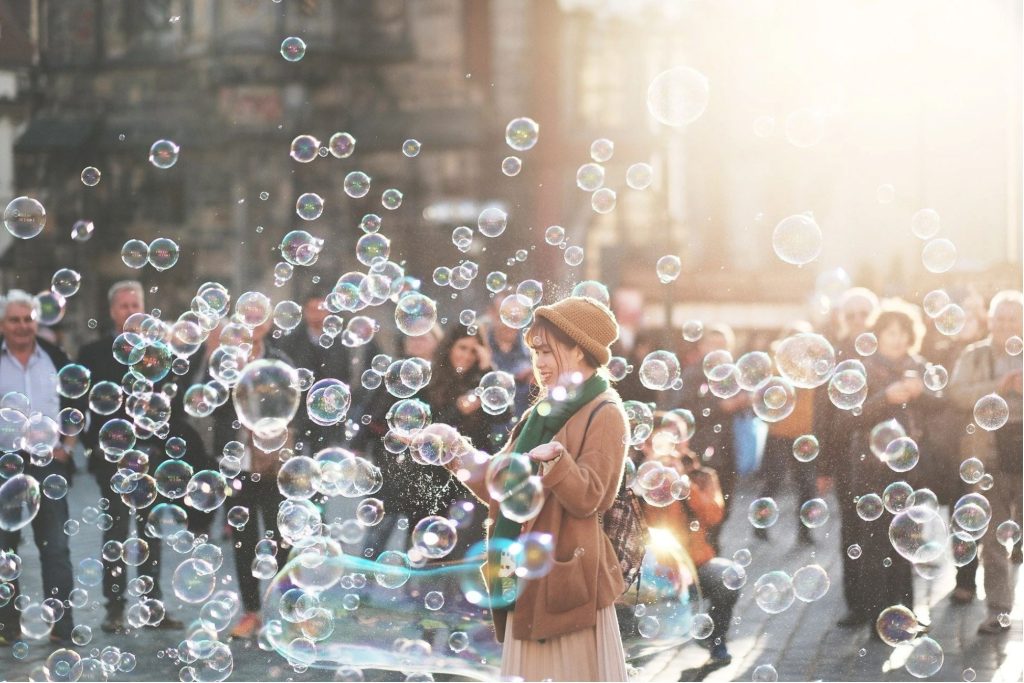 A person blowing bubbles in the air