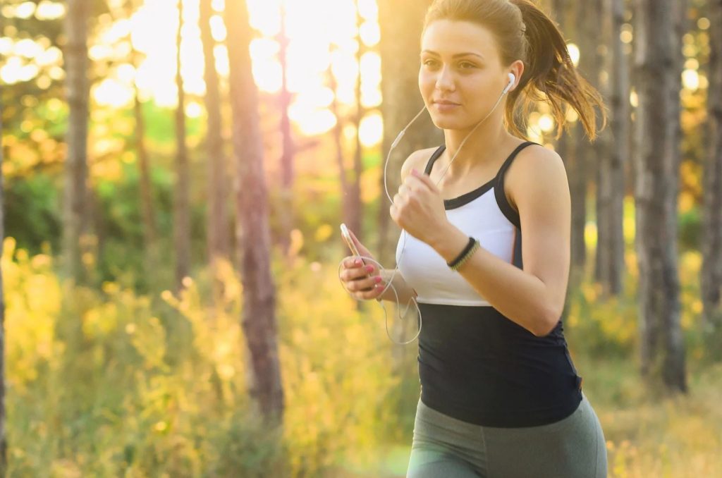 Girl jogging listening to a podcast